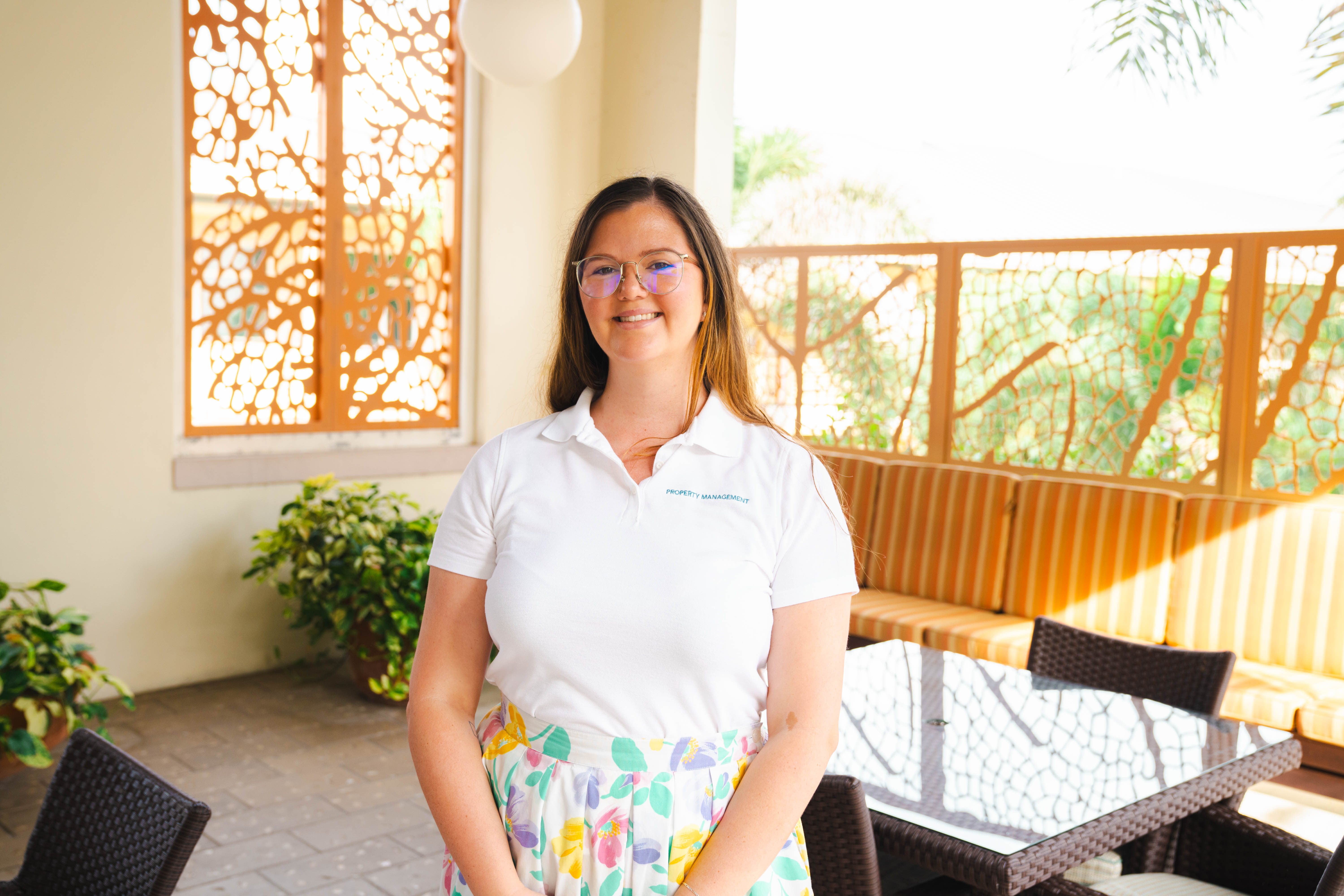 Woman in white shirt and floral skirt