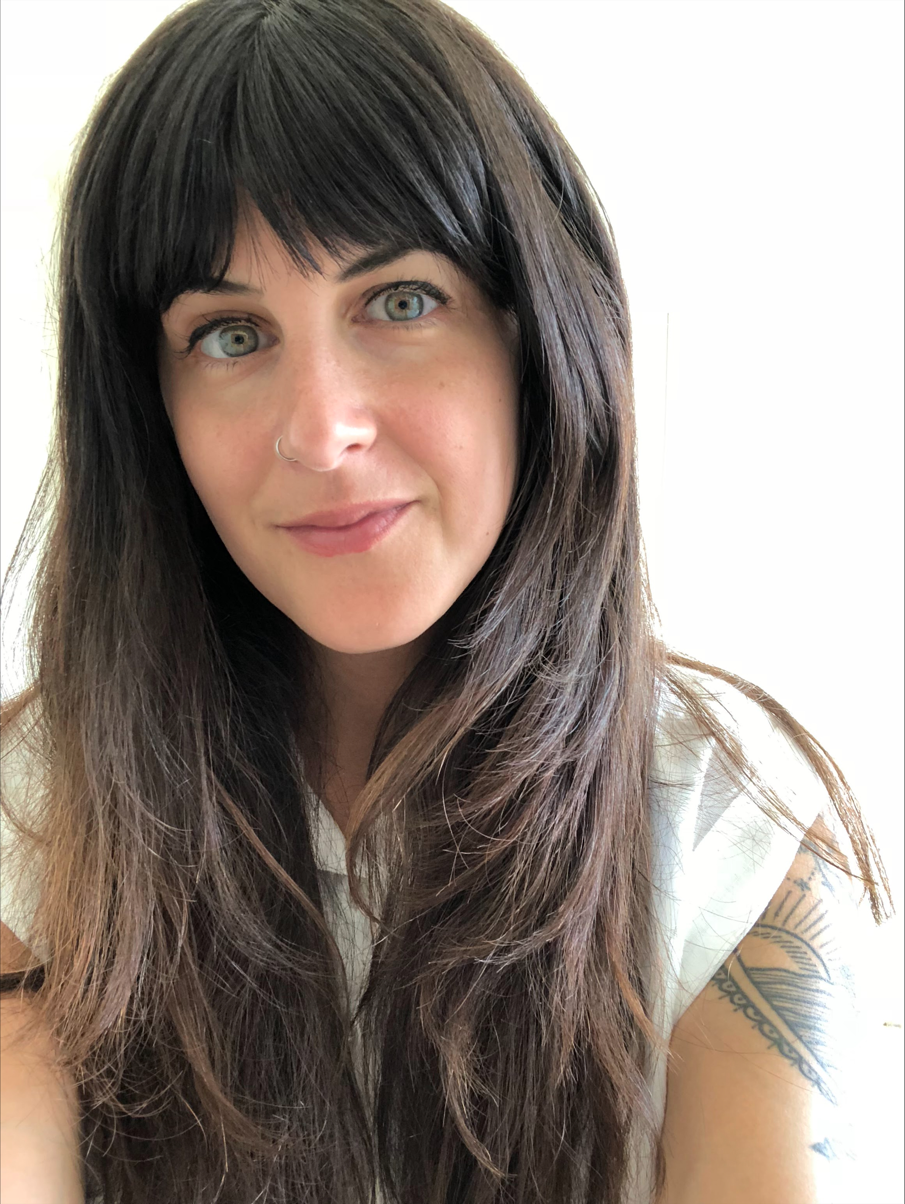 Dark haired woman smiles at camera