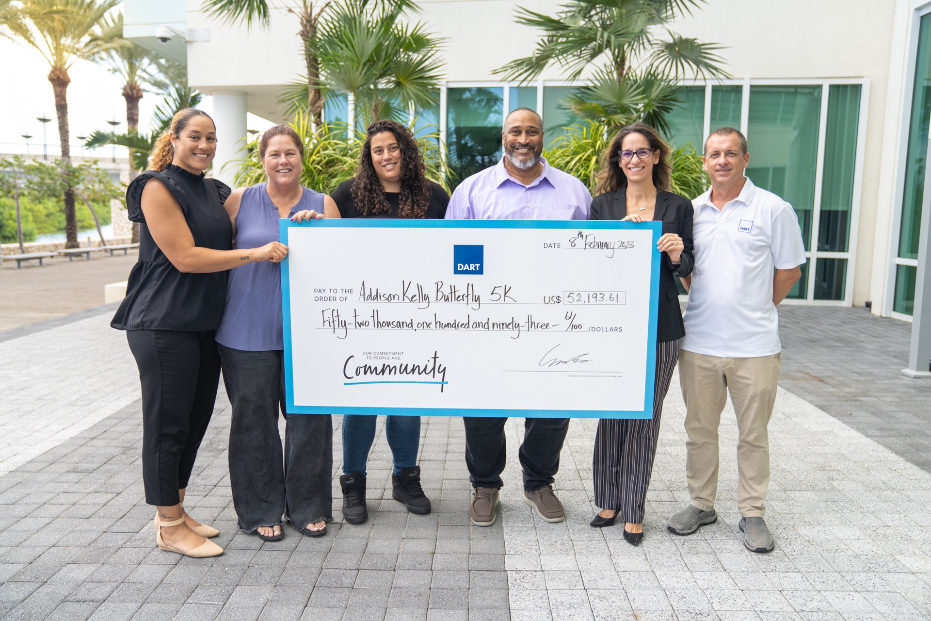 Family holding a cheque