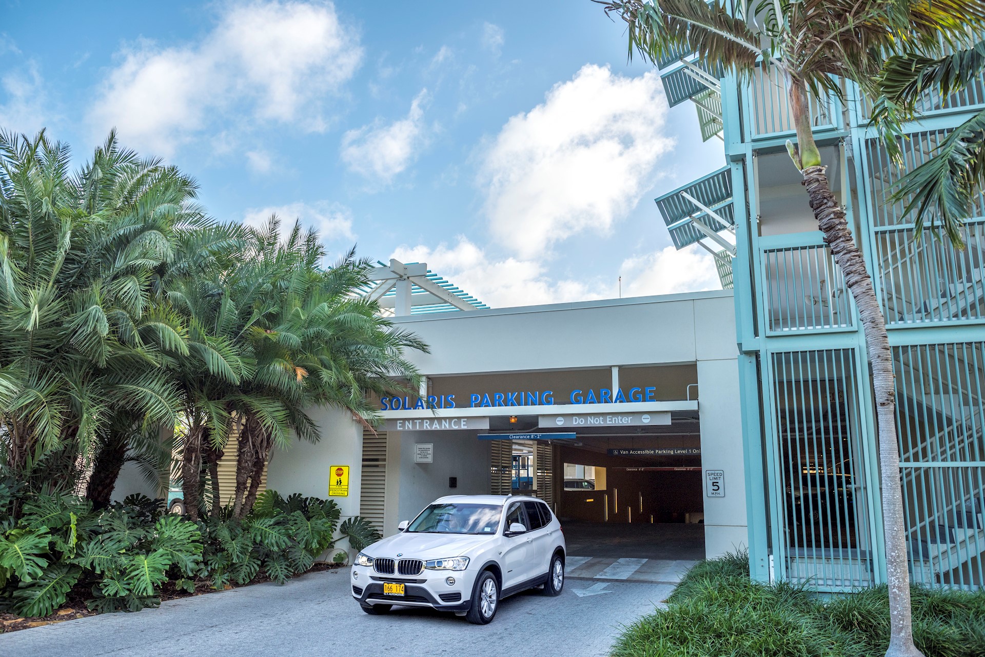 White car driving out of parking garage