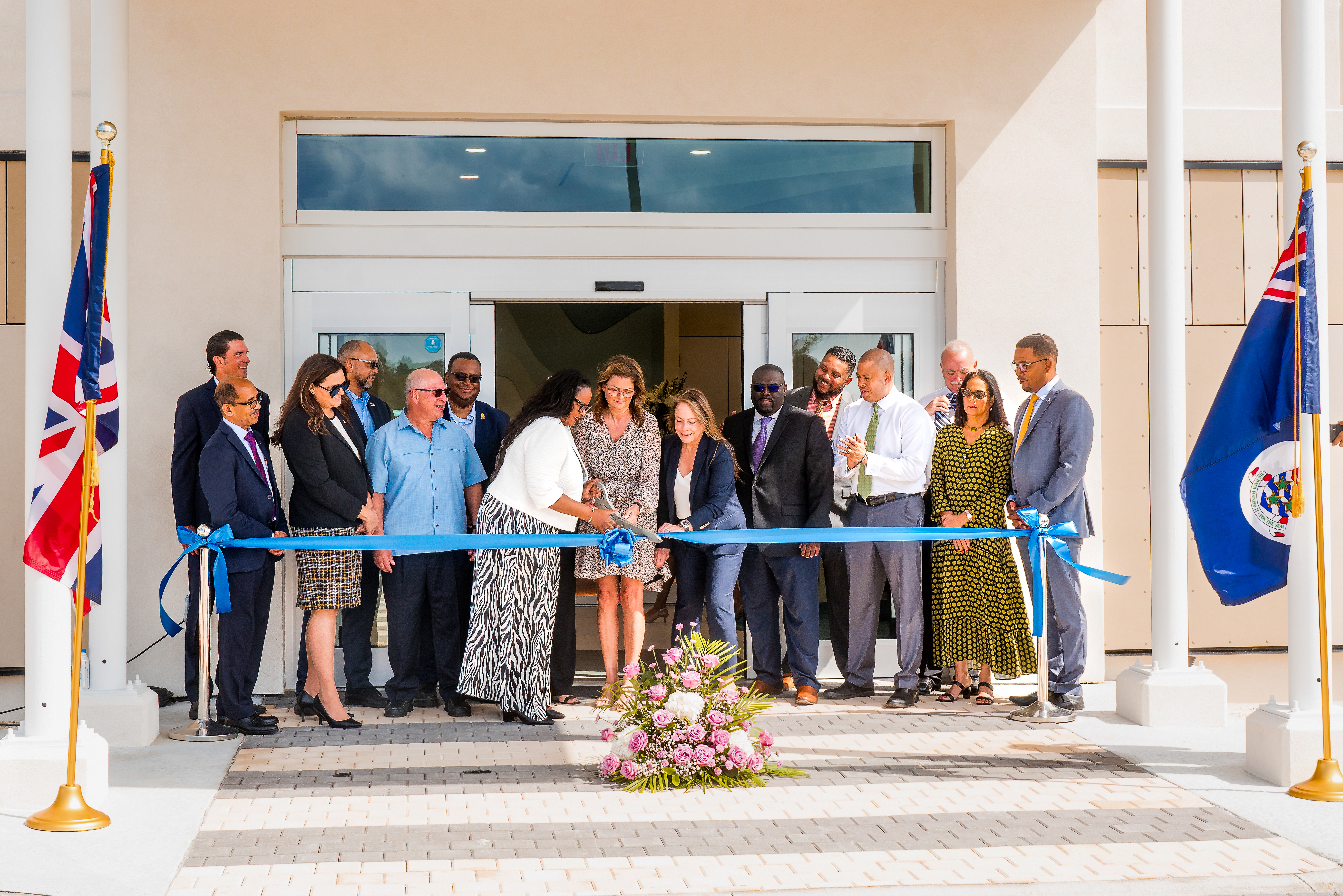 People gather to cut blue ribbon