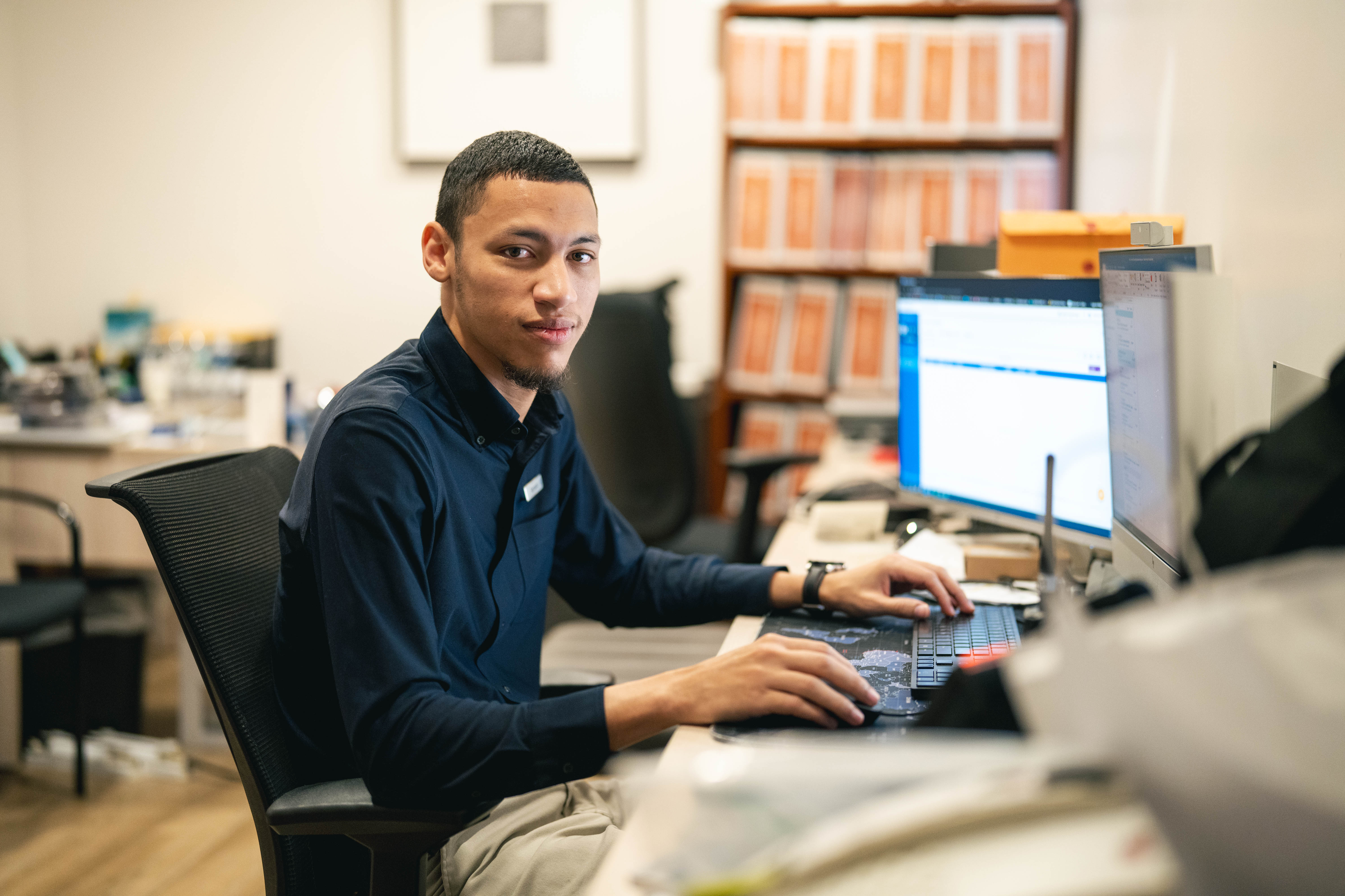 employee sitting at his desk in the back of house of a hotel