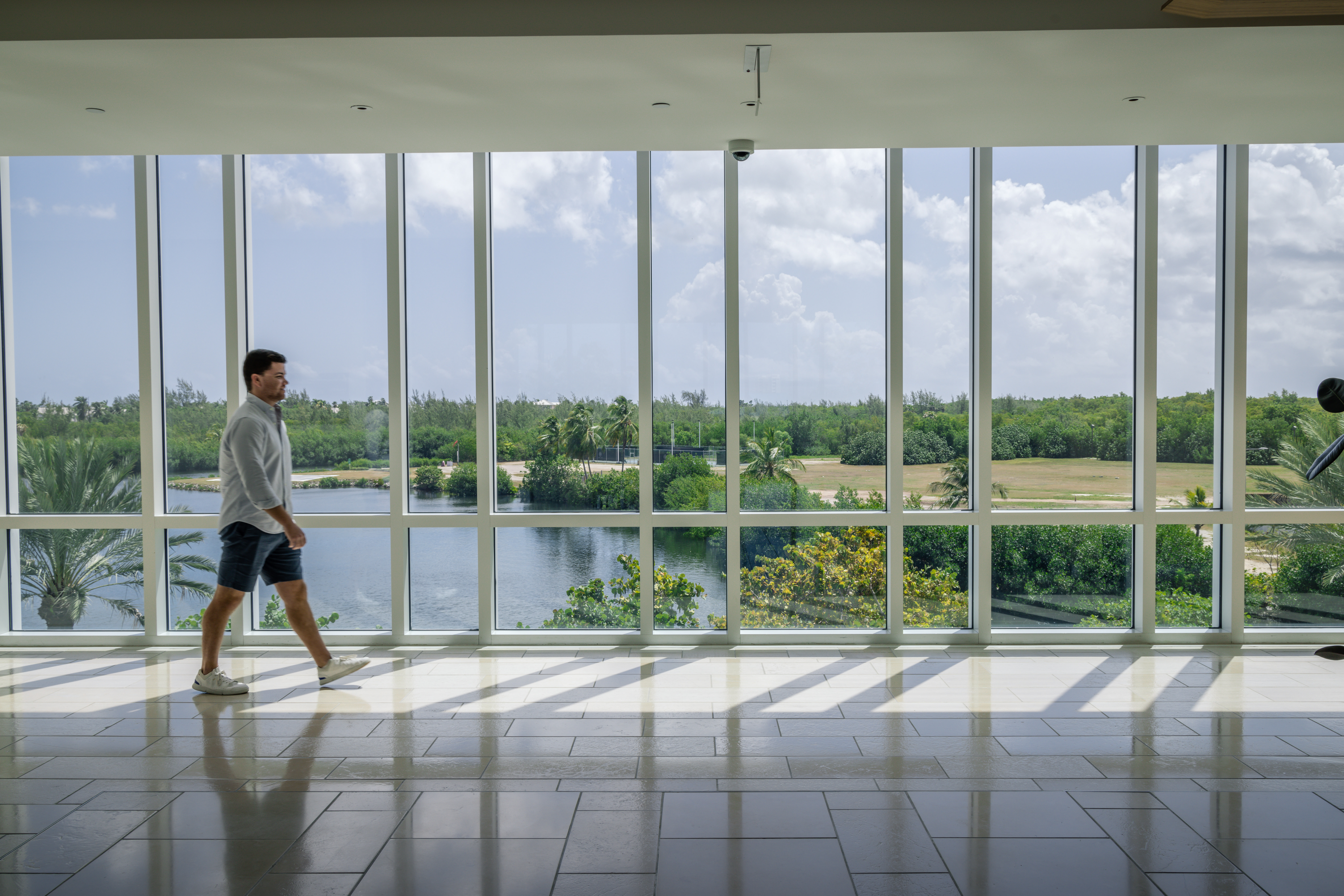 man walks in front of window