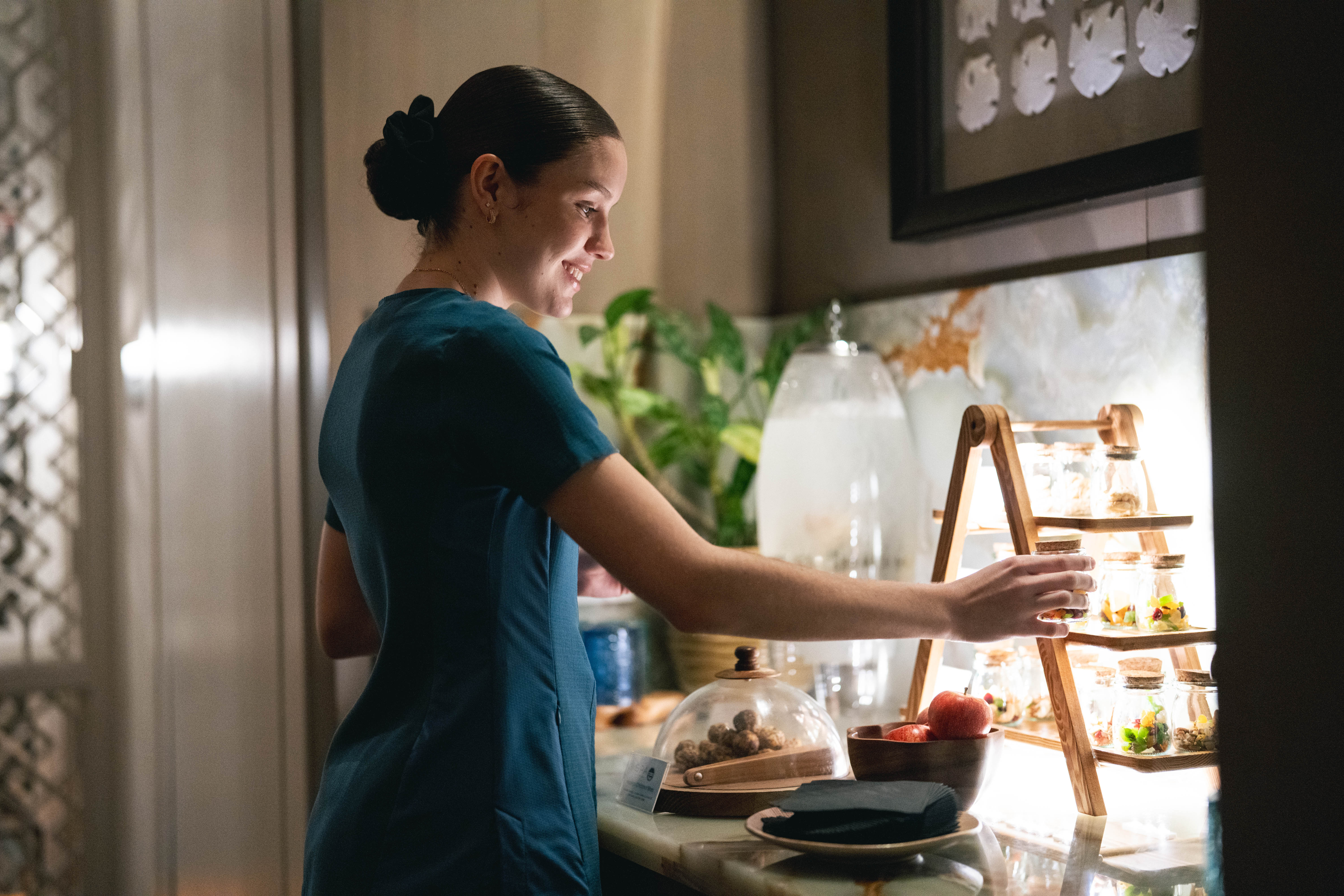 Spa employee prepares refreshments for guests