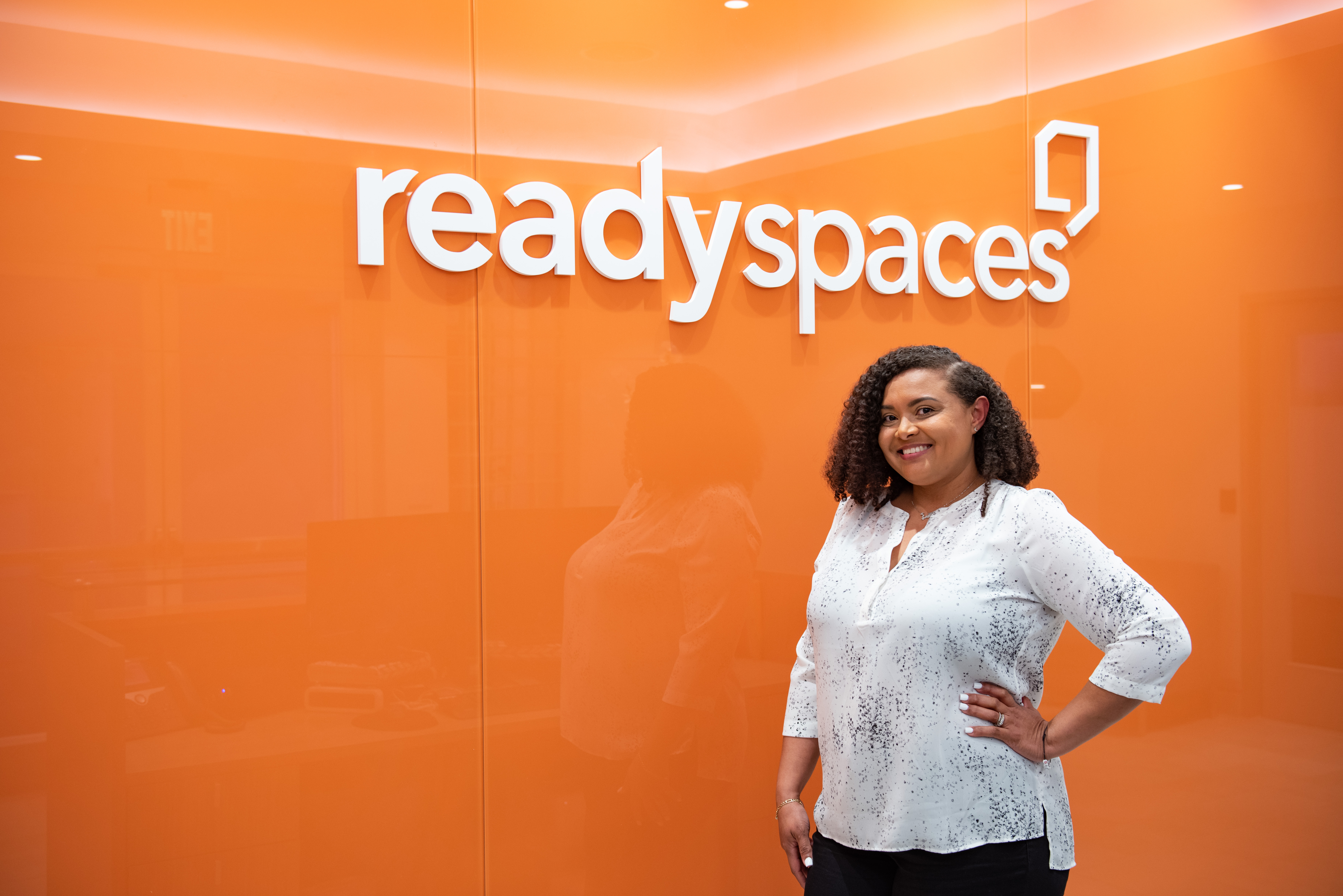 Woman standing in front of orange sign